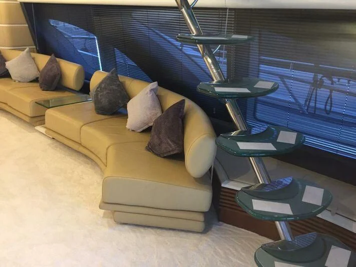a room with a couch and a table aboard AEGINA Yacht for Sale