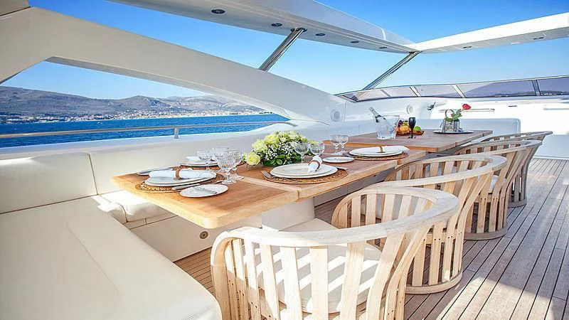 a room with a table and chairs aboard YVONNE Yacht for Sale