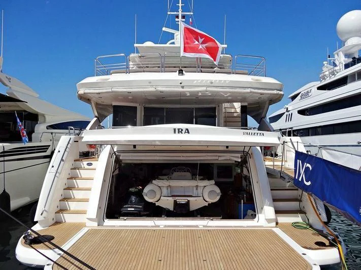 a boat with a flag on the front aboard YVONNE Yacht for Sale