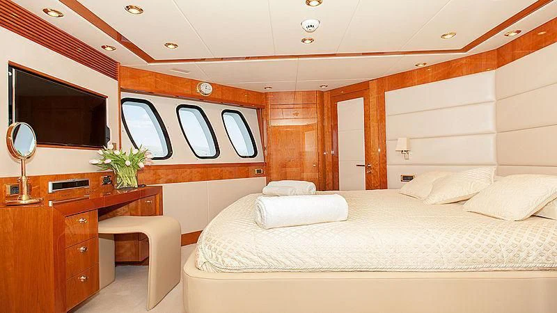 a room with a bed and a desk aboard YVONNE Yacht for Sale