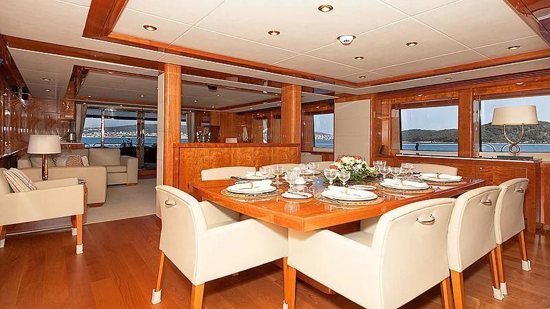 a dining table in a room aboard YVONNE Yacht for Sale