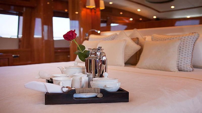 a table with a plate and a tray with food on it aboard YVONNE Yacht for Sale