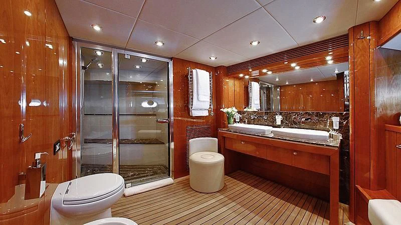 a bathroom with a tub toilet and sink aboard YVONNE Yacht for Sale