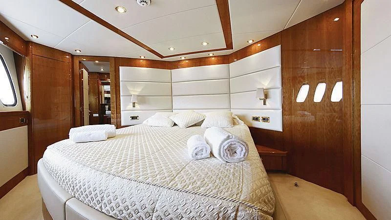 a bed with white sheets aboard YVONNE Yacht for Sale