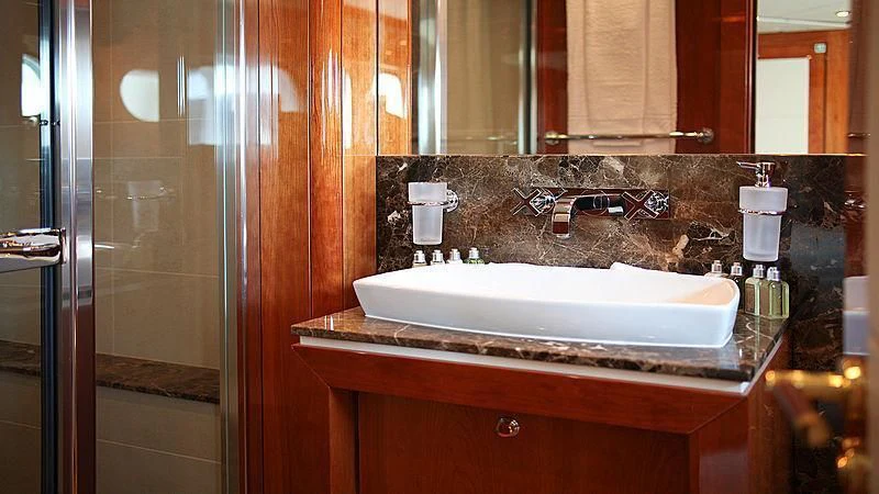 a bathroom sink with a mirror aboard YVONNE Yacht for Sale