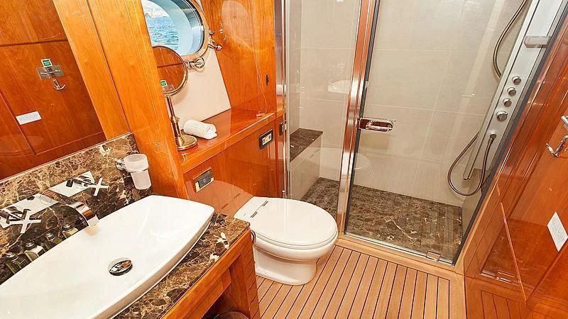 a bathroom with a glass shower aboard YVONNE Yacht for Sale