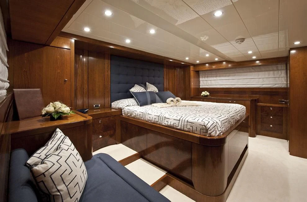 a room with a bed and a couch aboard MRS. WHITE Yacht for Sale