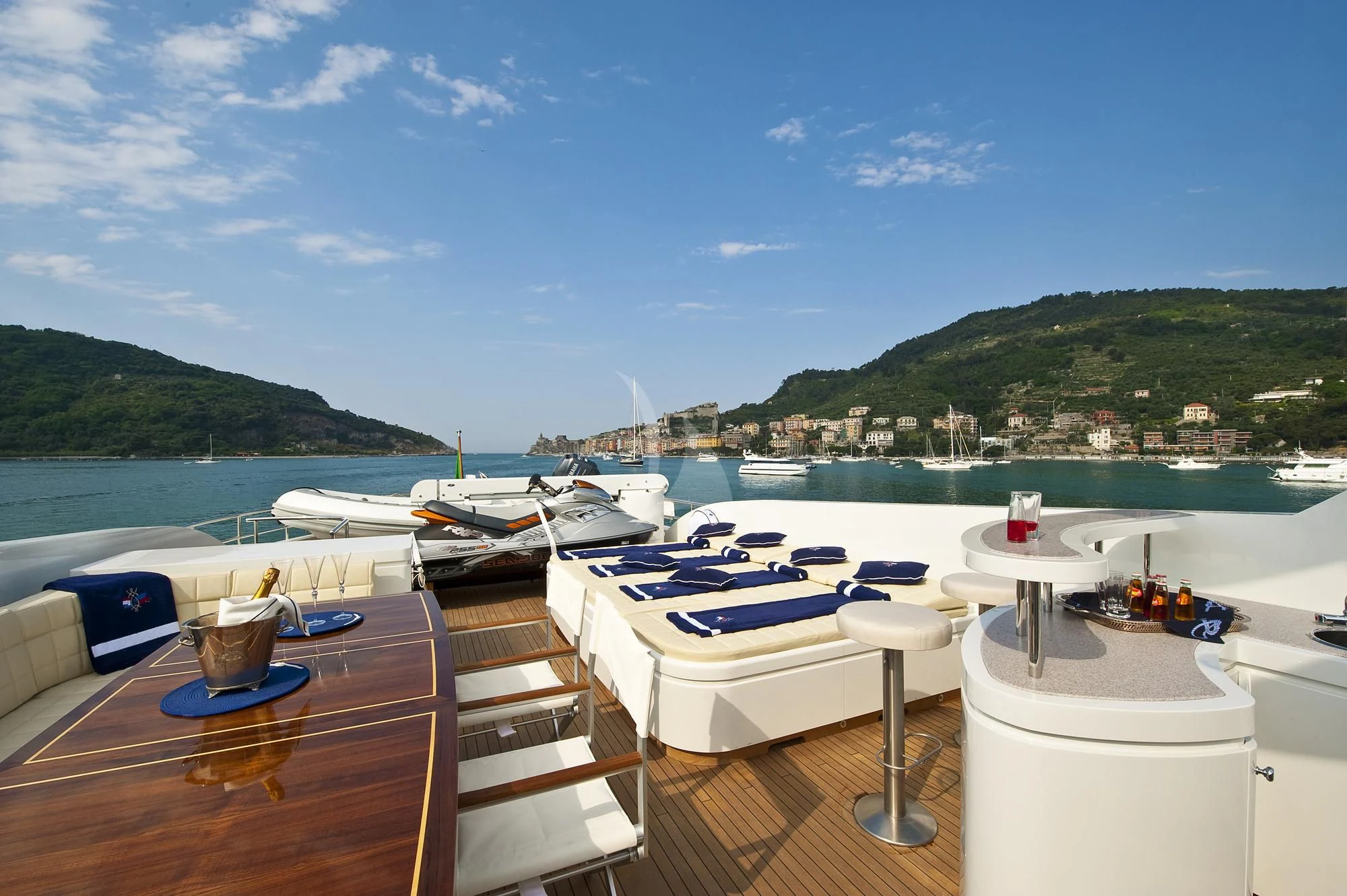 a deck with boats and a table on it aboard MRS. WHITE Yacht for Sale