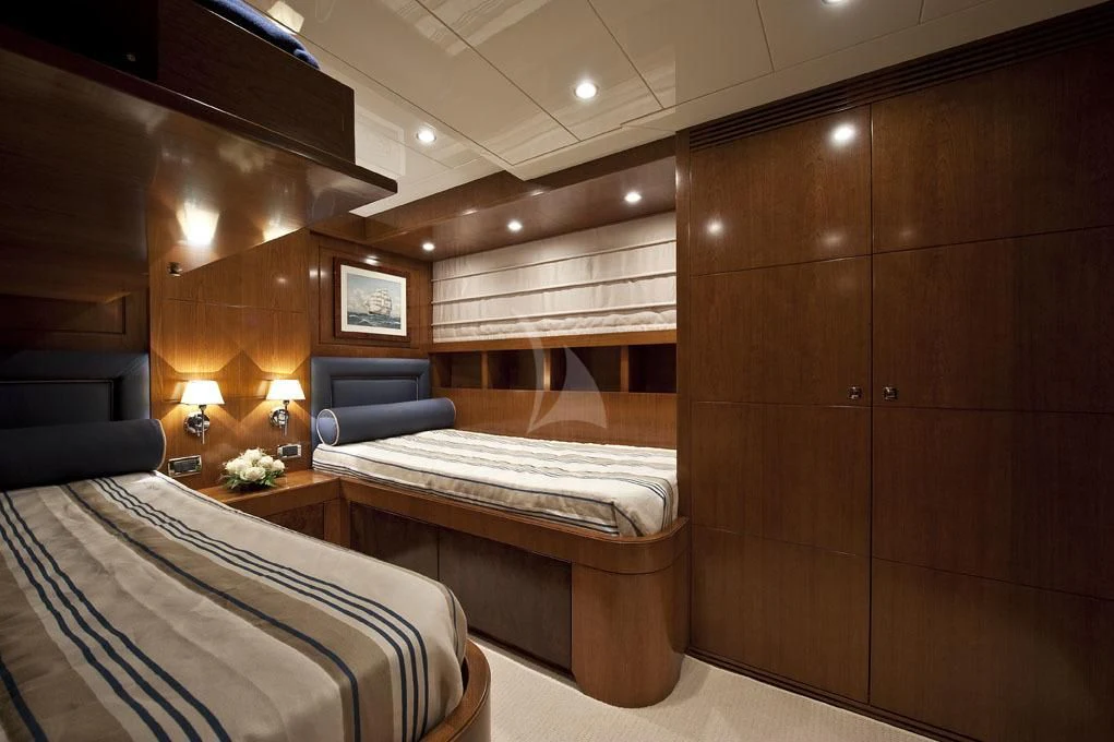 a room with a bed and a chair aboard MRS. WHITE Yacht for Sale