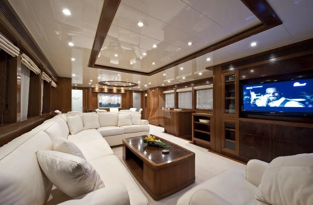 a living room with a large screen aboard MRS. WHITE Yacht for Sale