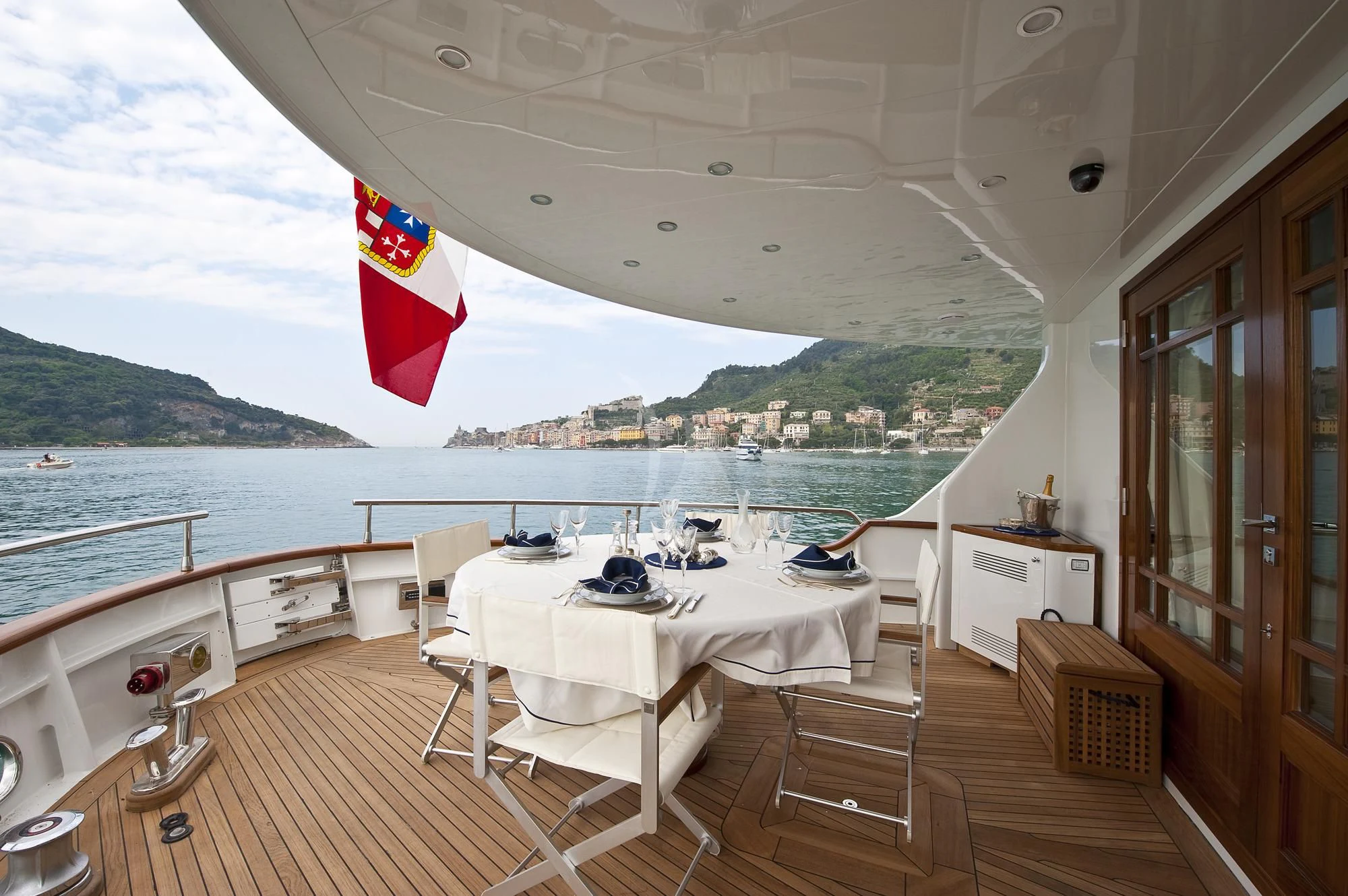 a deck with a table and chairs on it aboard MRS. WHITE Yacht for Sale