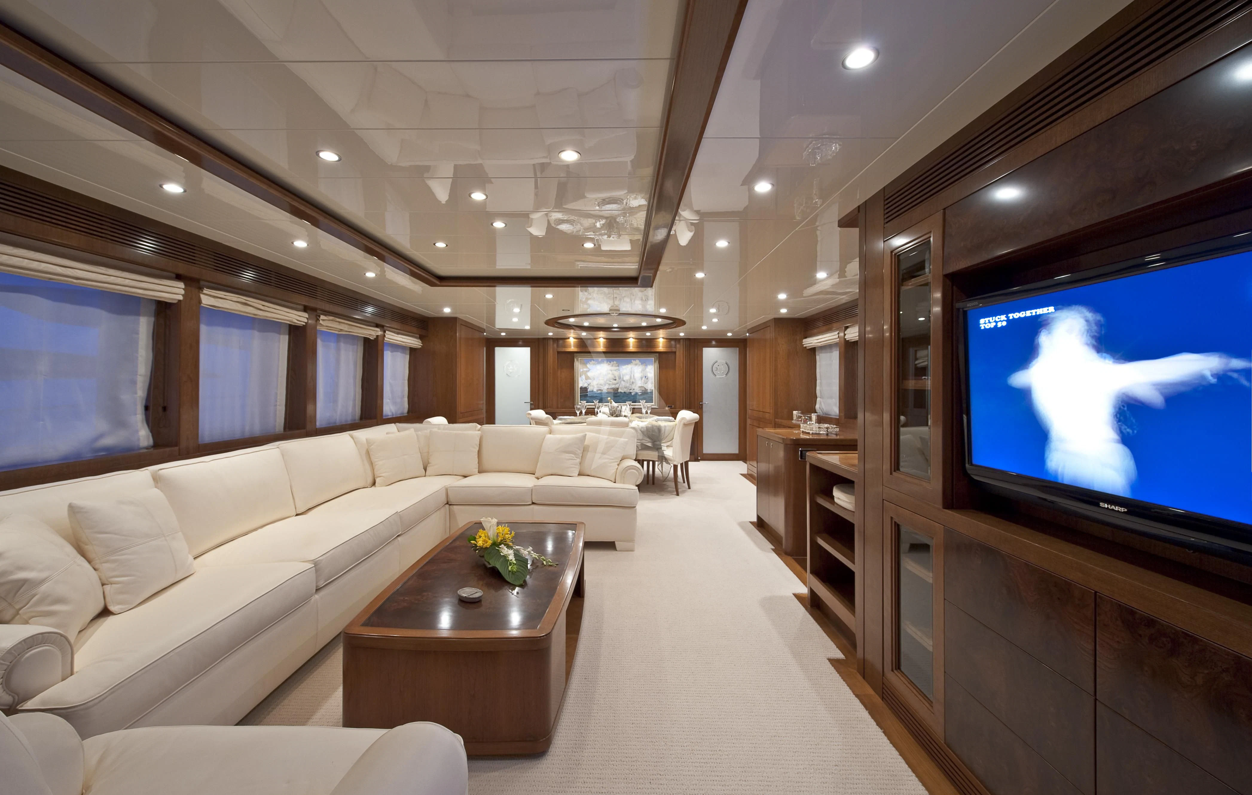 a living room with a large television aboard MRS. WHITE Yacht for Sale