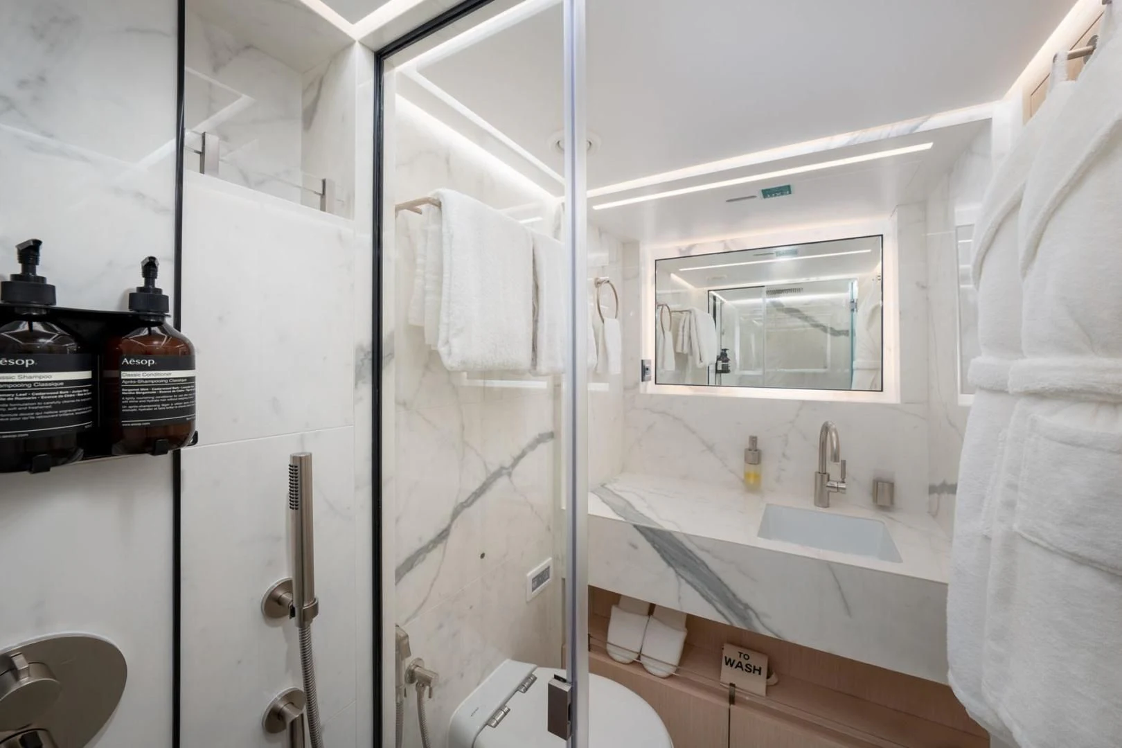 a bathroom with a glass shower aboard GOLD STAR Yacht for Charter