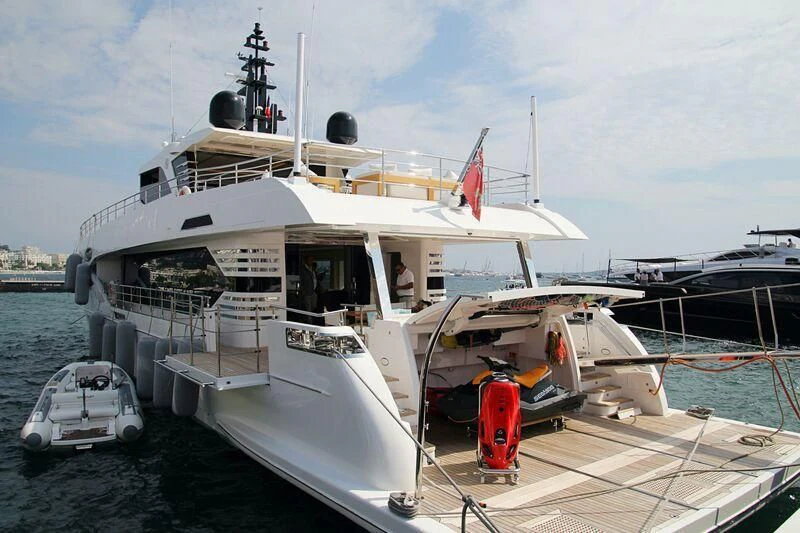 a large white boat with a red stripe on the front aboard GOLD STAR Yacht for Charter
