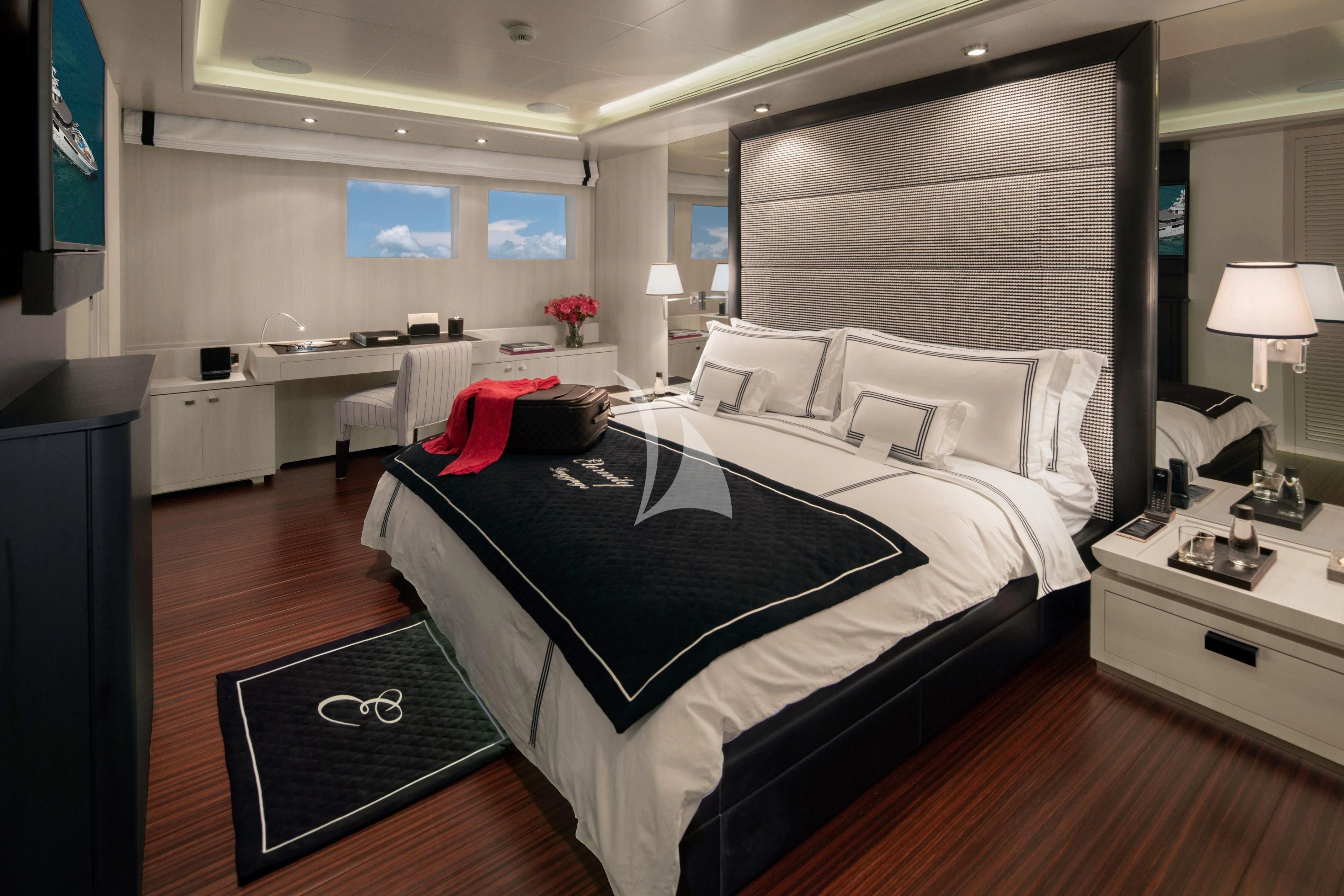 a room with a bed and a desk aboard ETERNITY Yacht for Sale