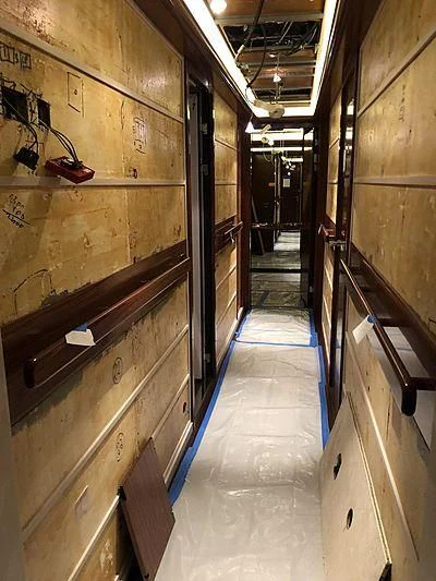 a long hallway with wooden walls aboard ETERNITY Yacht for Sale