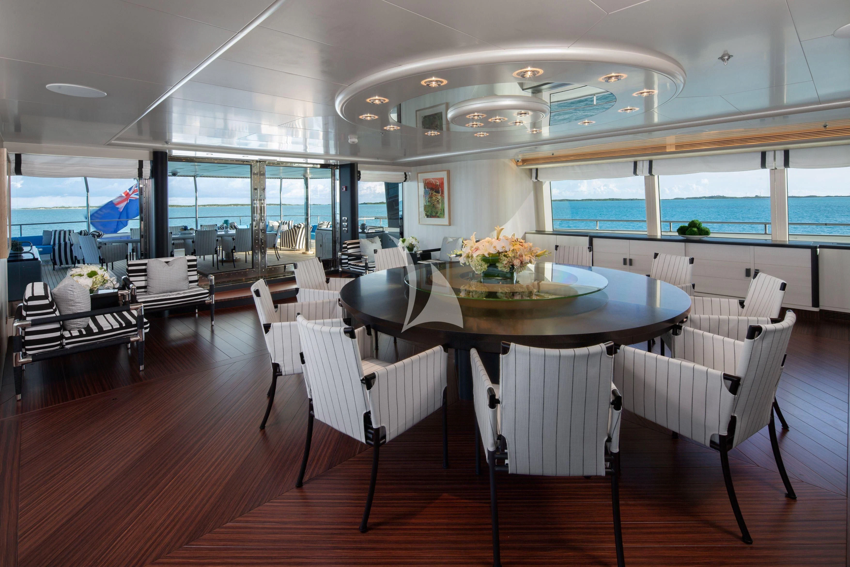 a room with tables and chairs aboard ETERNITY Yacht for Sale