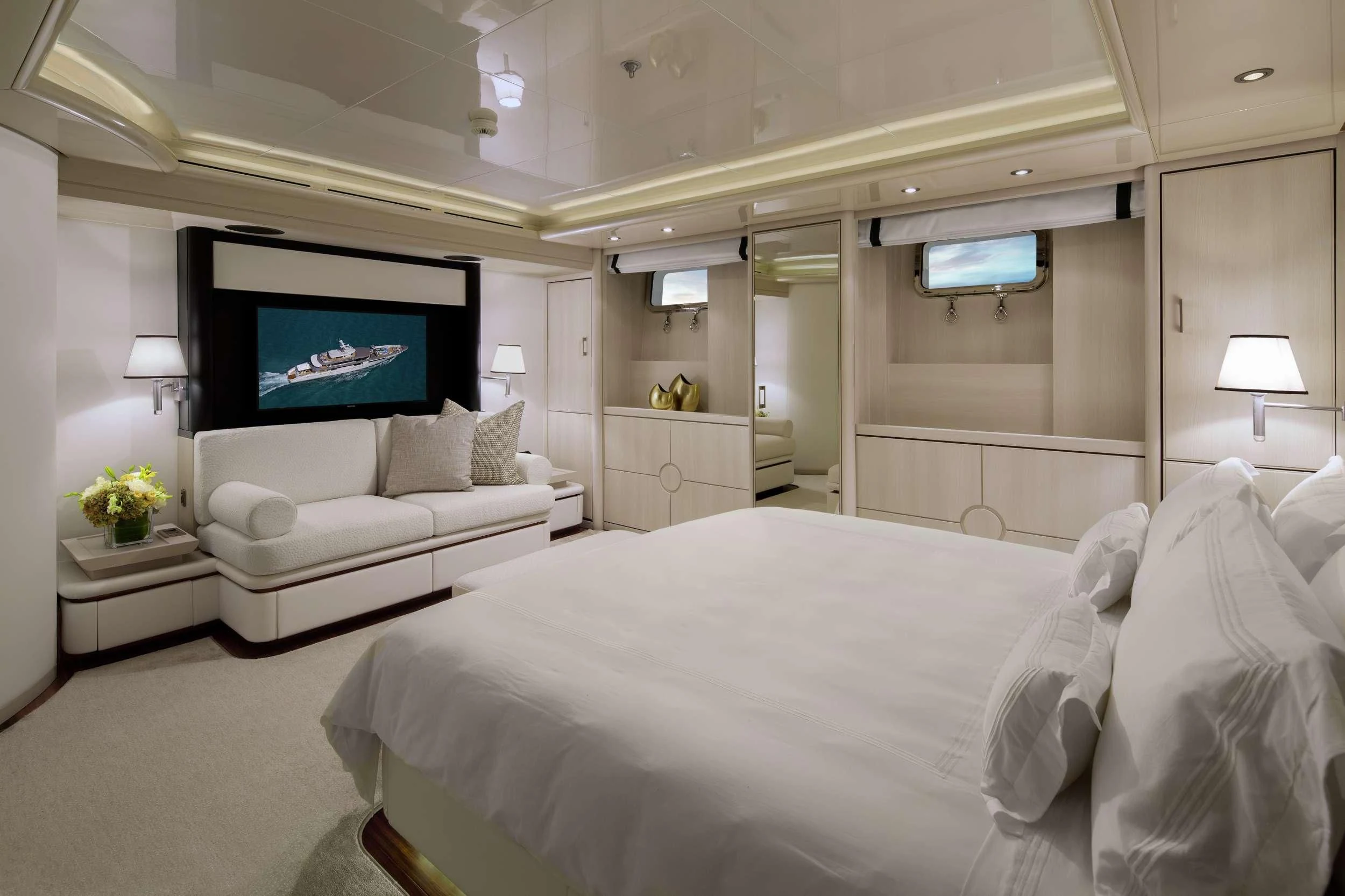 a large white bedroom with a large bed and a flat screen tv aboard ETERNITY Yacht for Sale