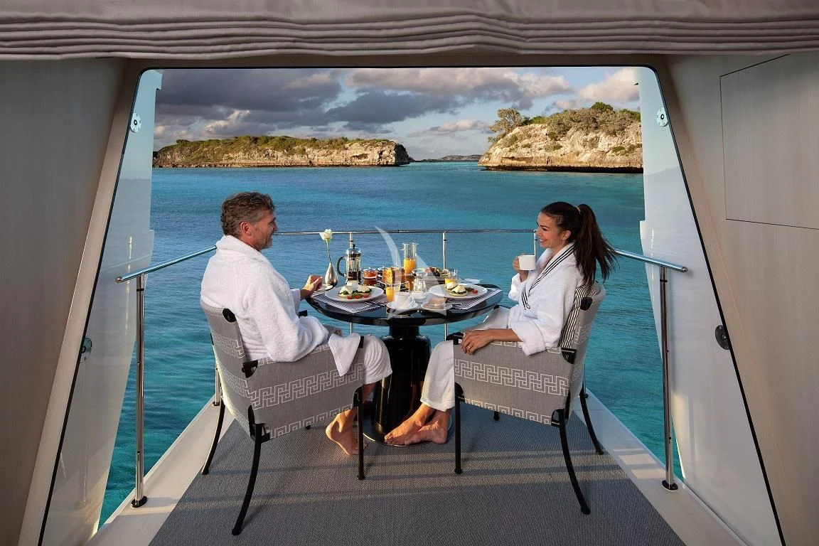 a couple eating at a table aboard ETERNITY Yacht for Sale