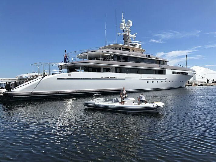 a large white boat with a person standing on the front aboard ETERNITY Yacht for Sale