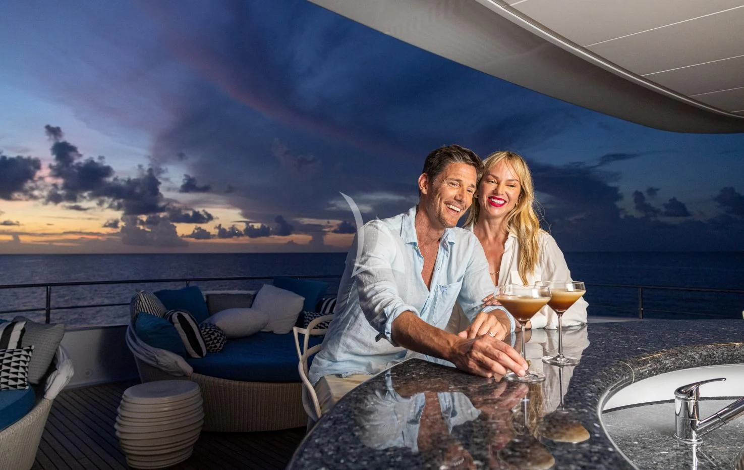 a man and woman holding glasses of wine on a boat aboard ETERNITY Yacht for Sale