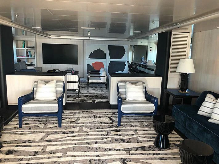 a room with a couch and a tv aboard ETERNITY Yacht for Sale