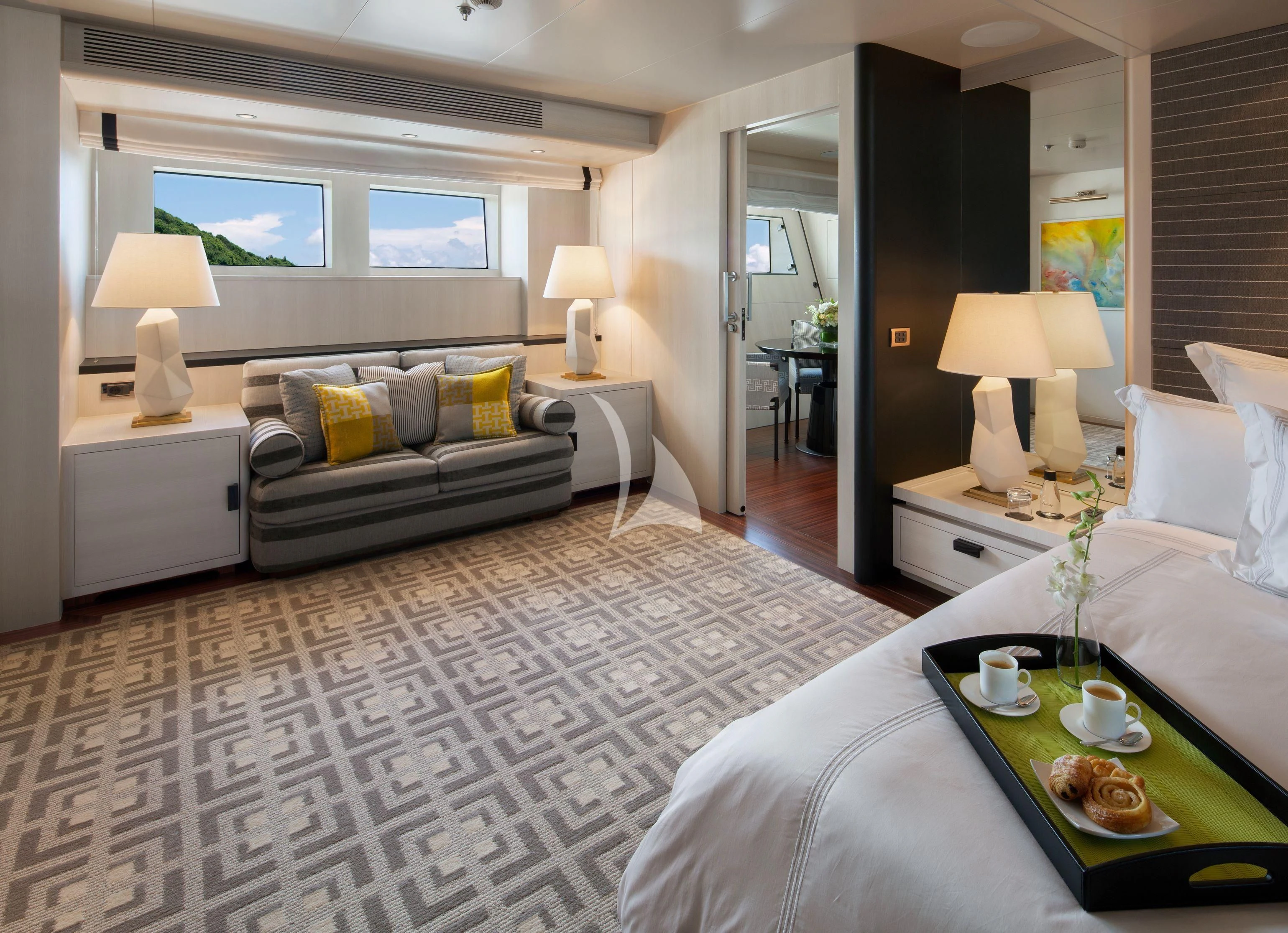 a bedroom with a bed and a table aboard ETERNITY Yacht for Sale