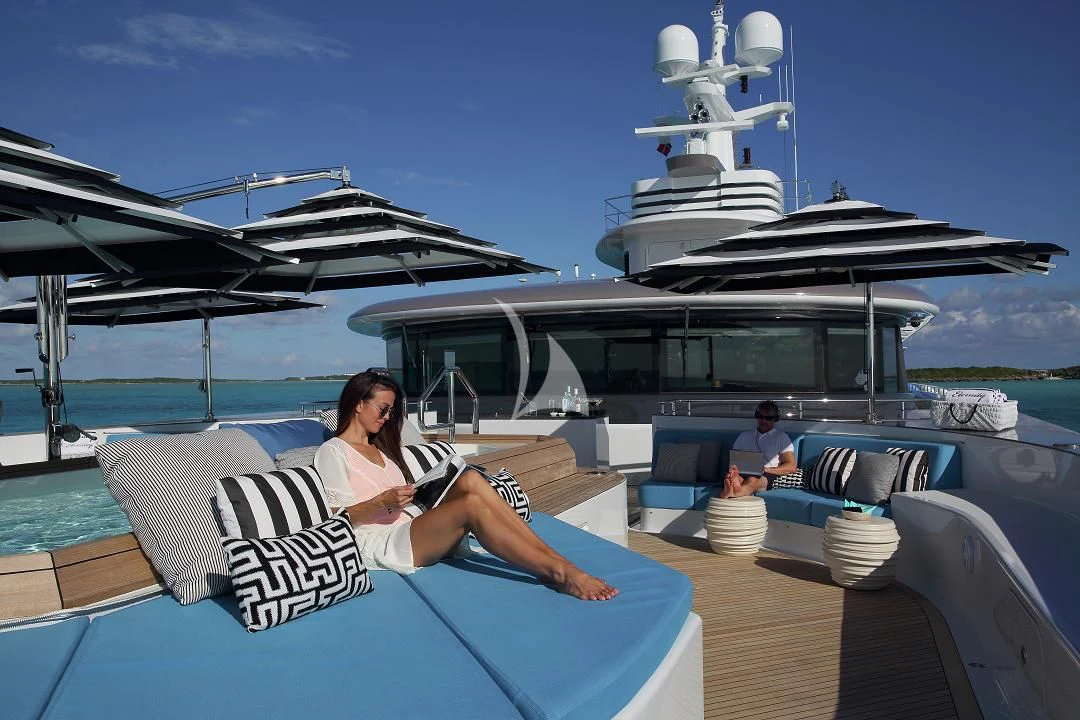 a person sitting on a lounge chair on a boat aboard ETERNITY Yacht for Sale