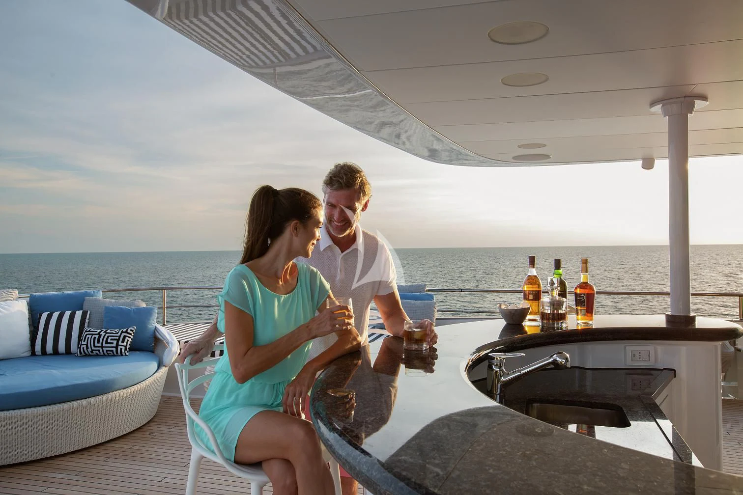a couple sitting on a couch aboard ETERNITY Yacht for Sale