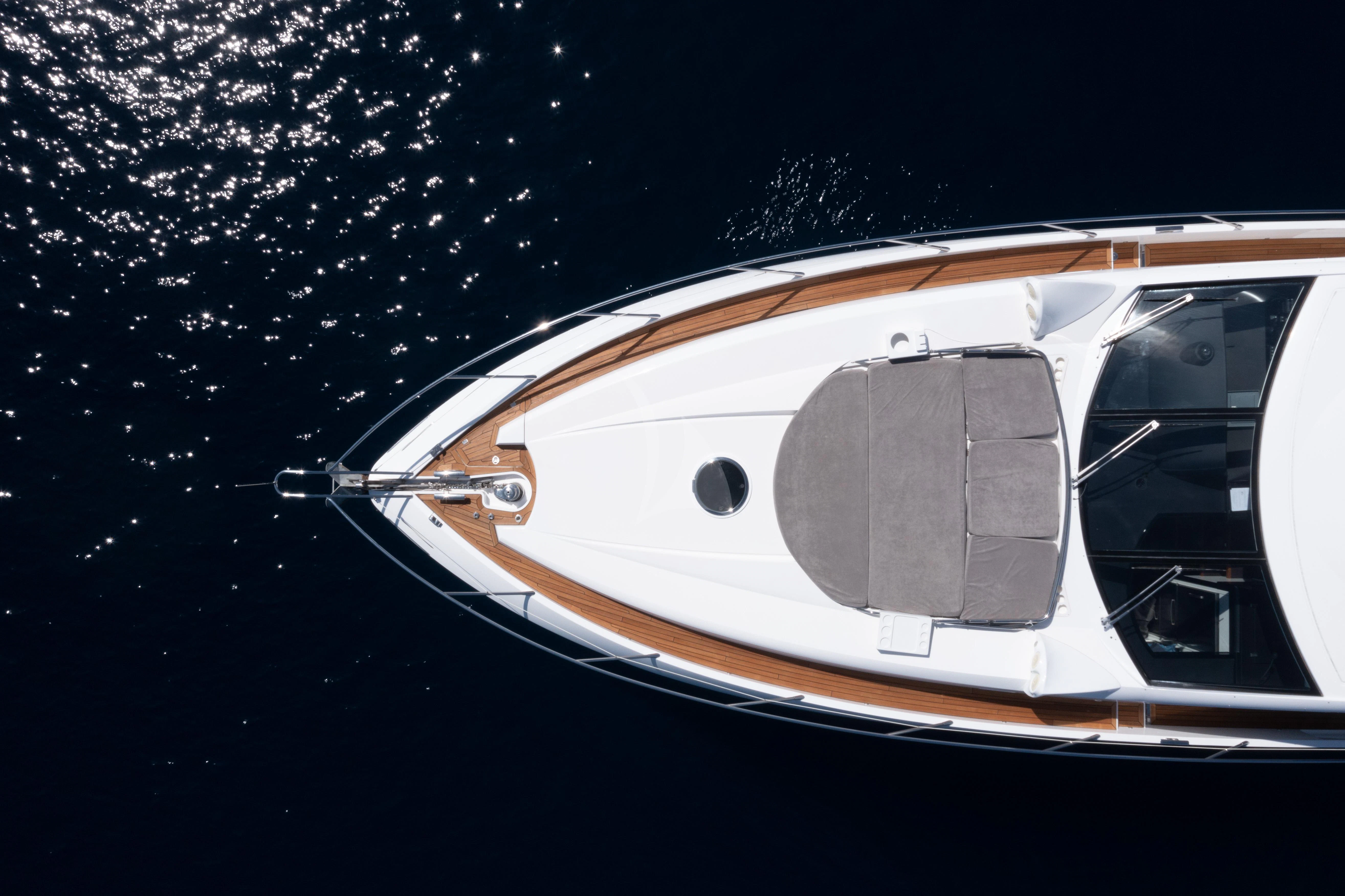 a white car with a round window aboard STAR OF SEVEN SEAS Yacht for Sale
