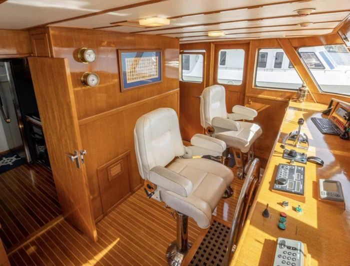 a room with a desk and chairs aboard SEA CZAR Yacht for Sale