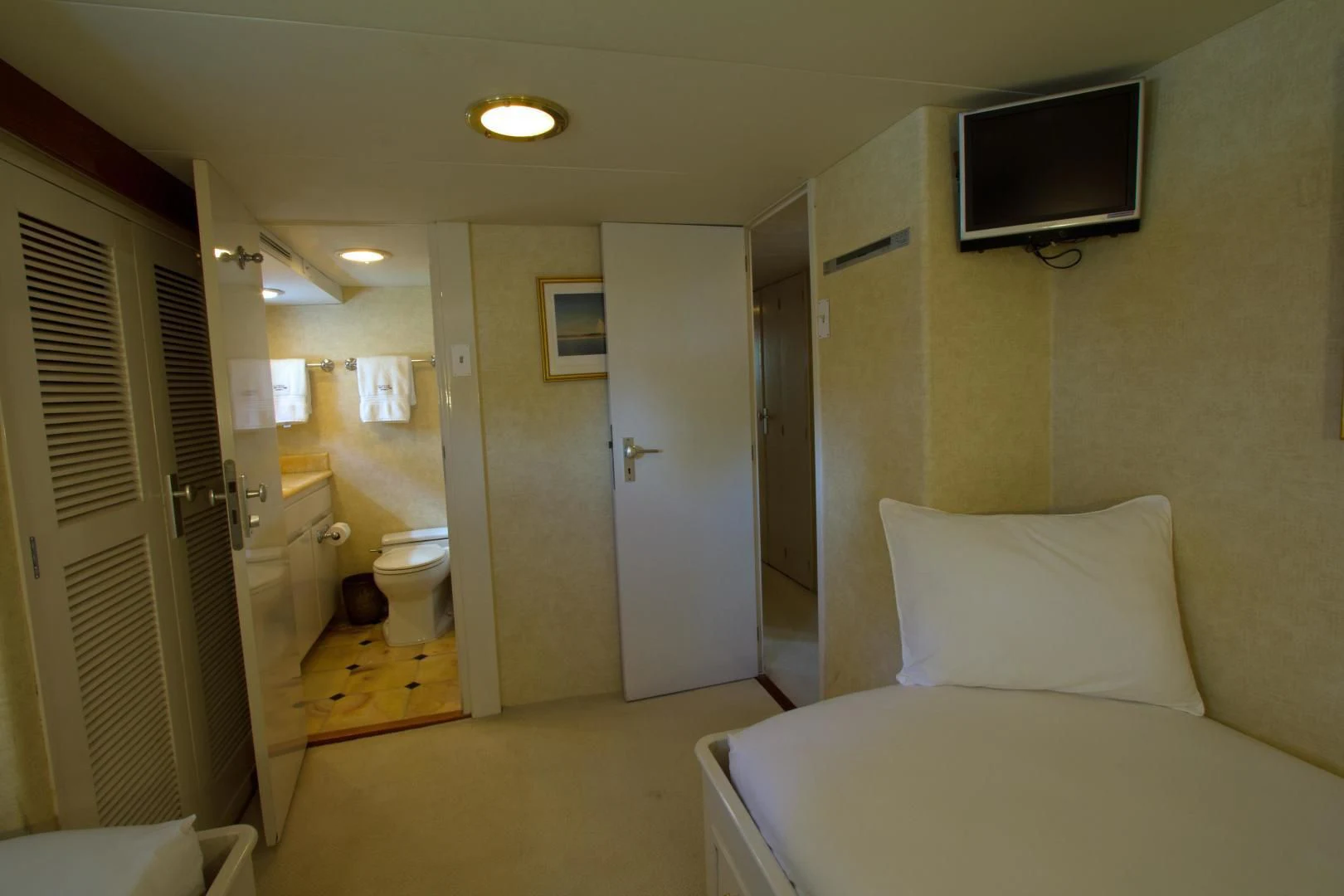 a hotel room with a bed and tv aboard SEA CZAR Yacht for Sale