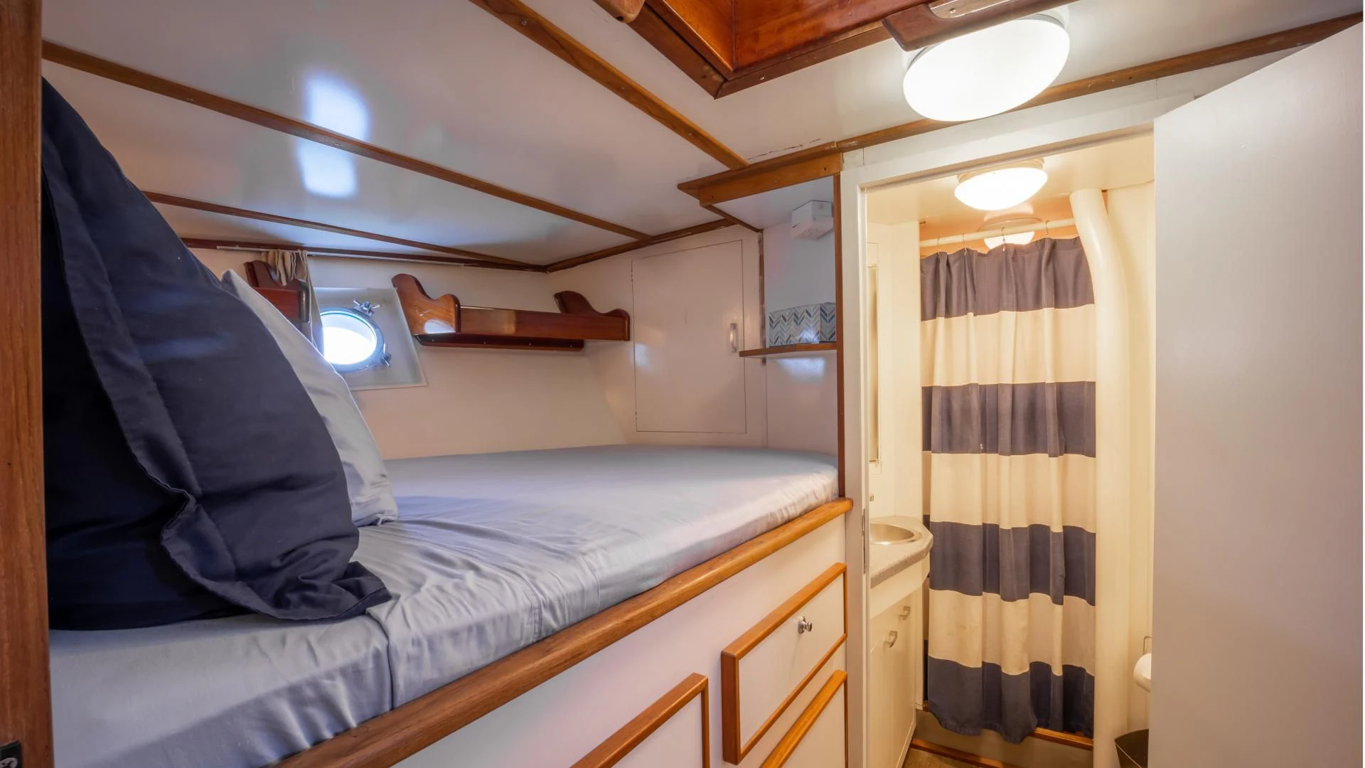a room with a bed and a window aboard SEA CZAR Yacht for Sale