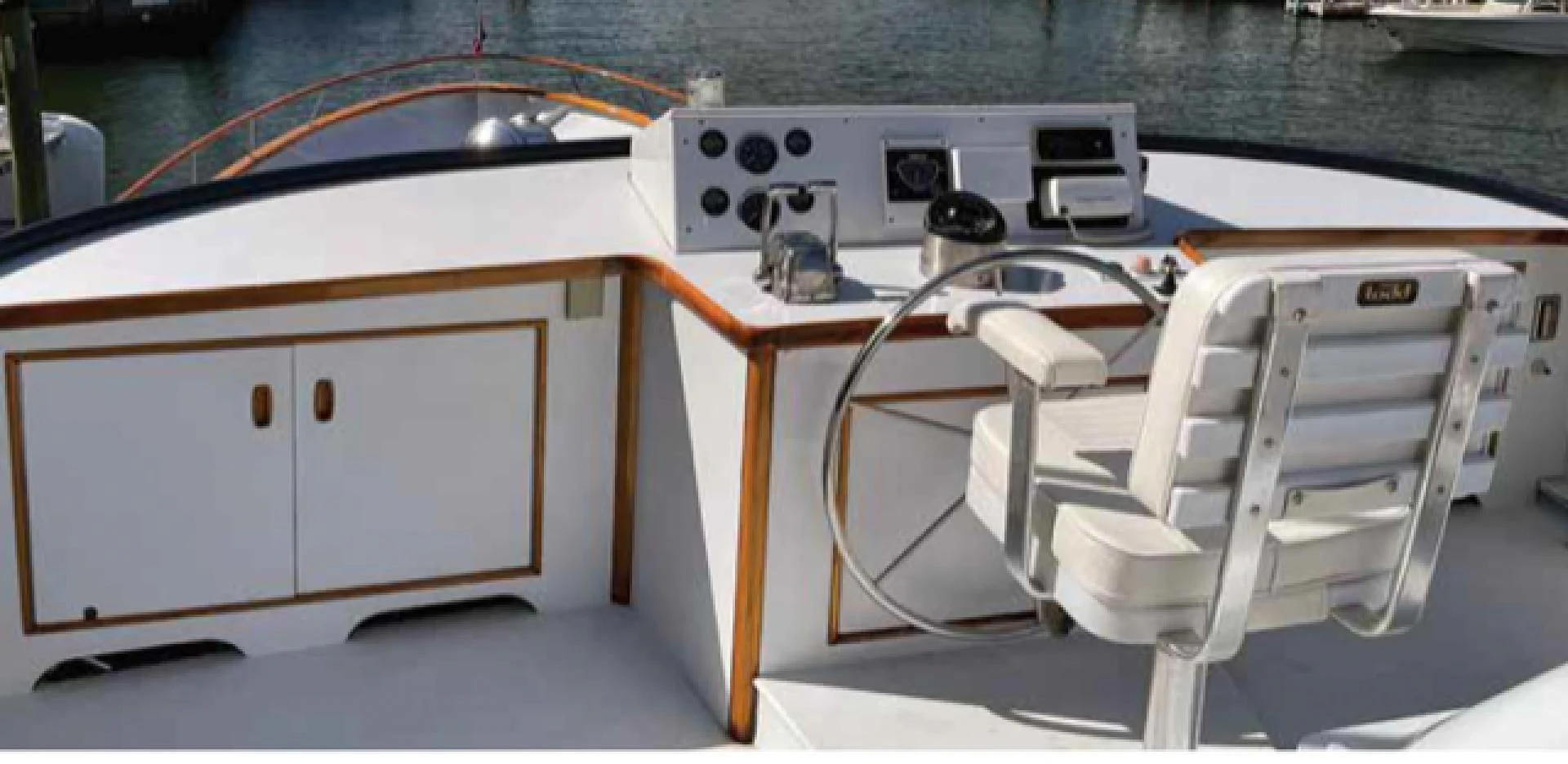 a white chair next to a stove aboard SEA CZAR Yacht for Sale