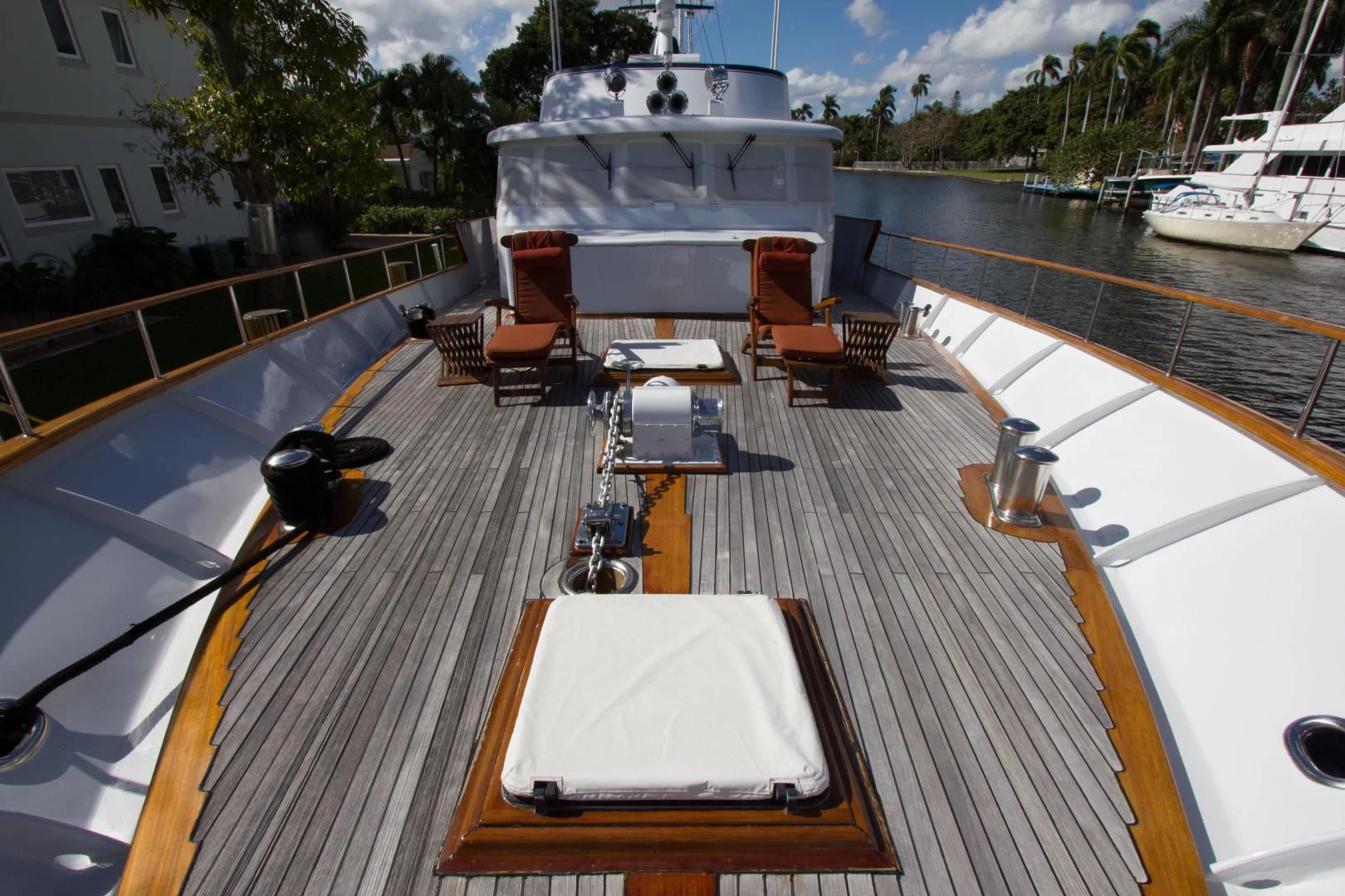 a deck with a table and chairs on it aboard SEA CZAR Yacht for Sale