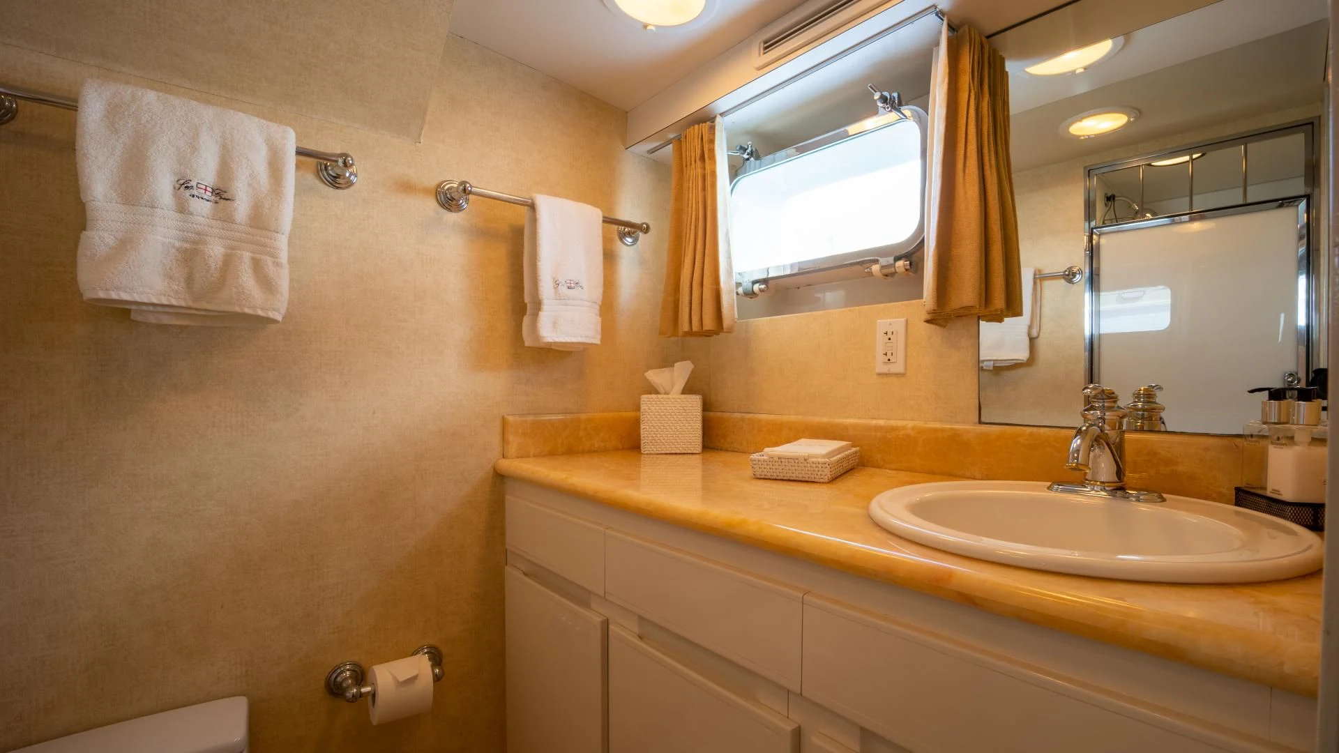 a bathroom with a sink and towels aboard SEA CZAR Yacht for Sale