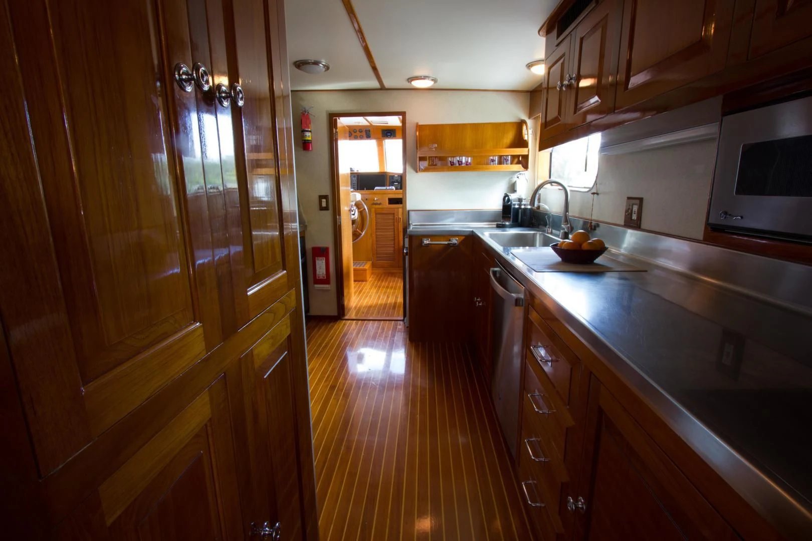 a kitchen with wooden cabinets aboard SEA CZAR Yacht for Sale