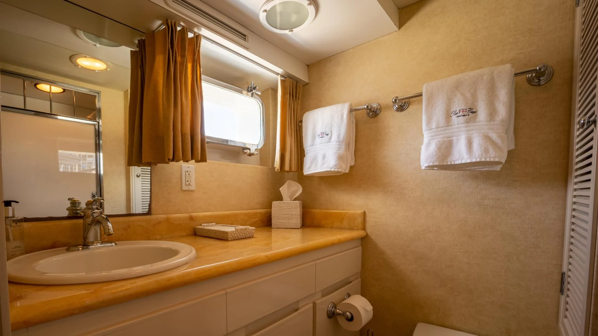 a bathroom with a sink and towels aboard SEA CZAR Yacht for Sale