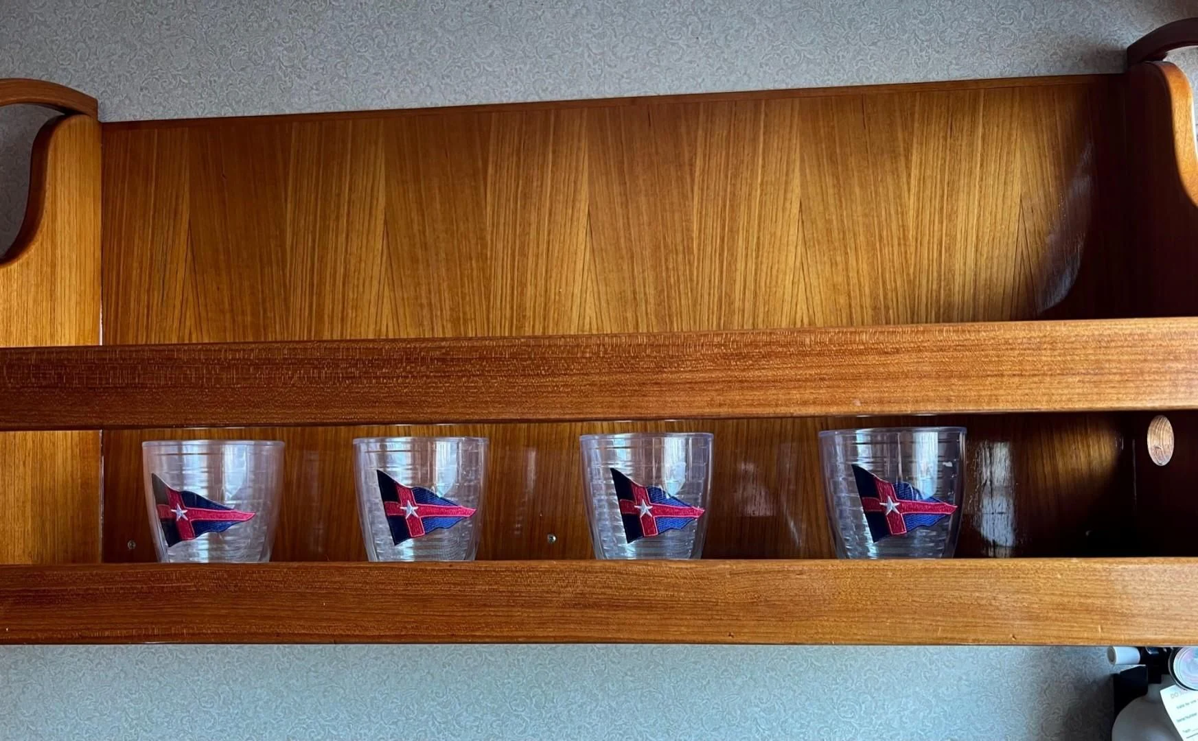 a group of red shoes on a wooden shelf aboard SEA CZAR Yacht for Sale