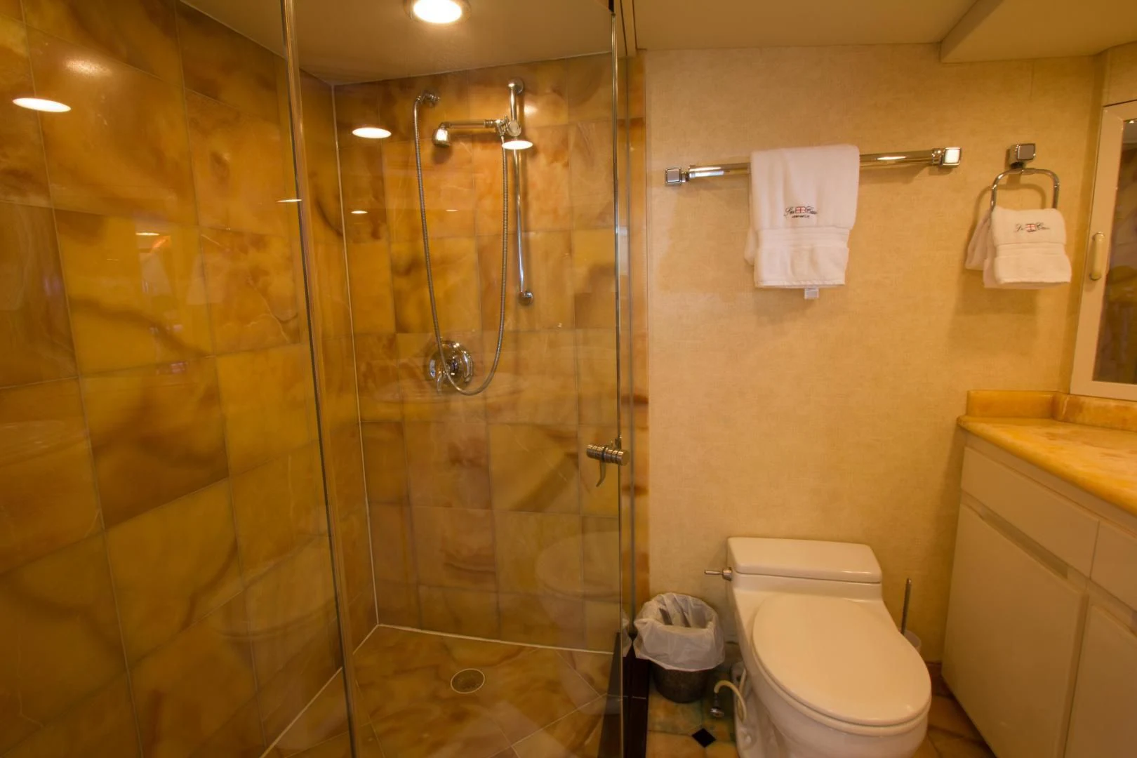 a bathroom with a glass shower aboard SEA CZAR Yacht for Sale