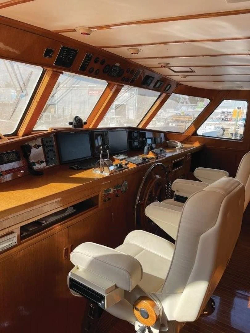 a room with a table and chairs aboard SEA CZAR Yacht for Sale