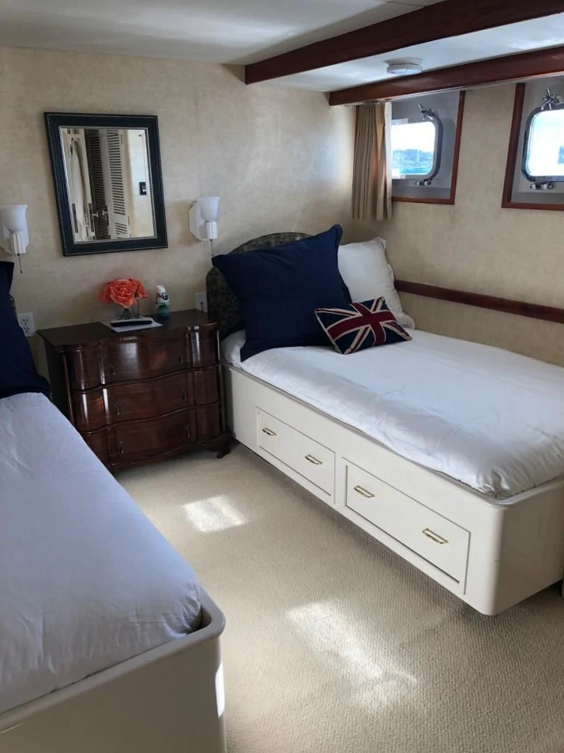a bedroom with two beds aboard SEA CZAR Yacht for Sale
