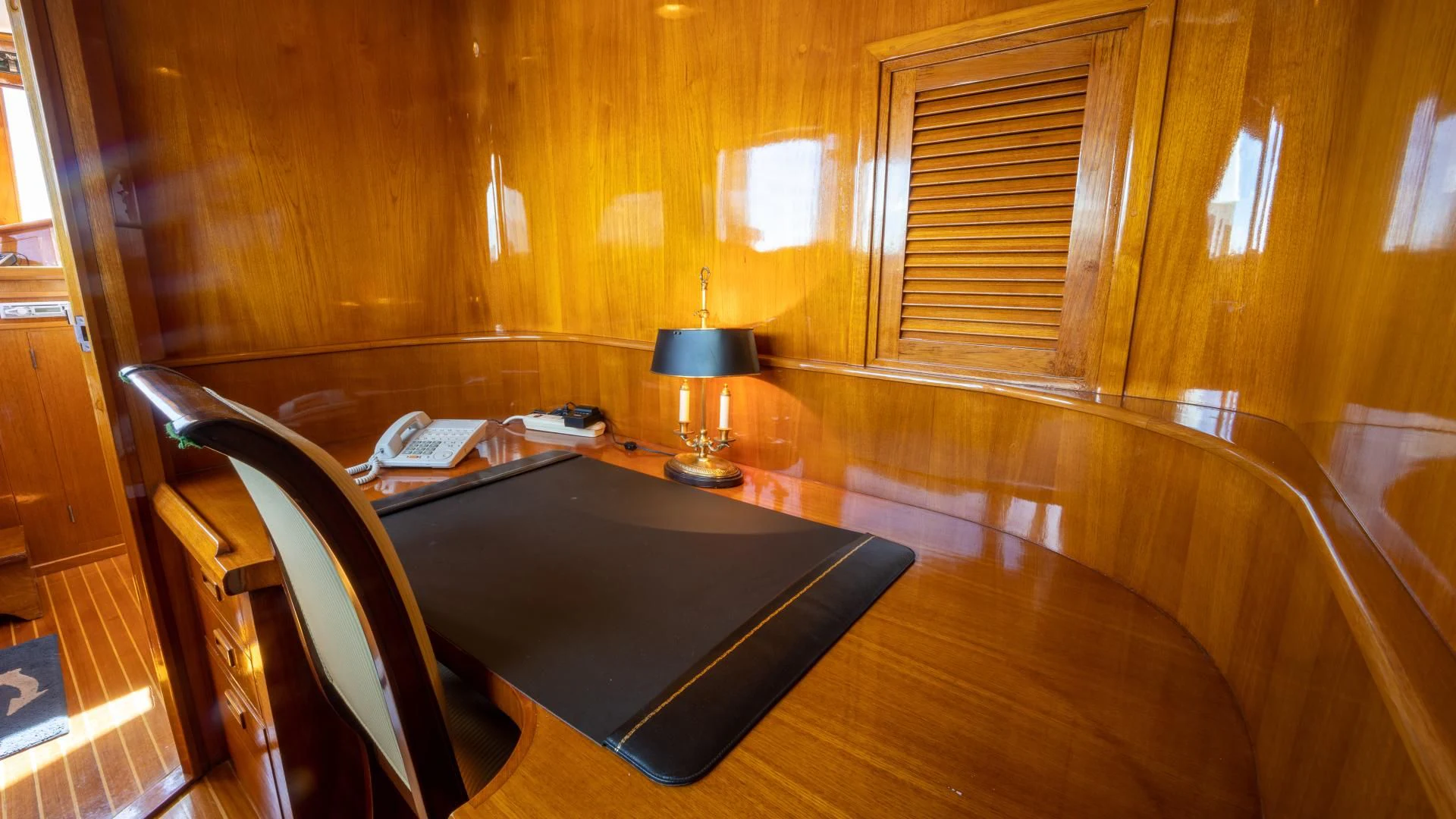 a room with a table and a lamp aboard SEA CZAR Yacht for Sale