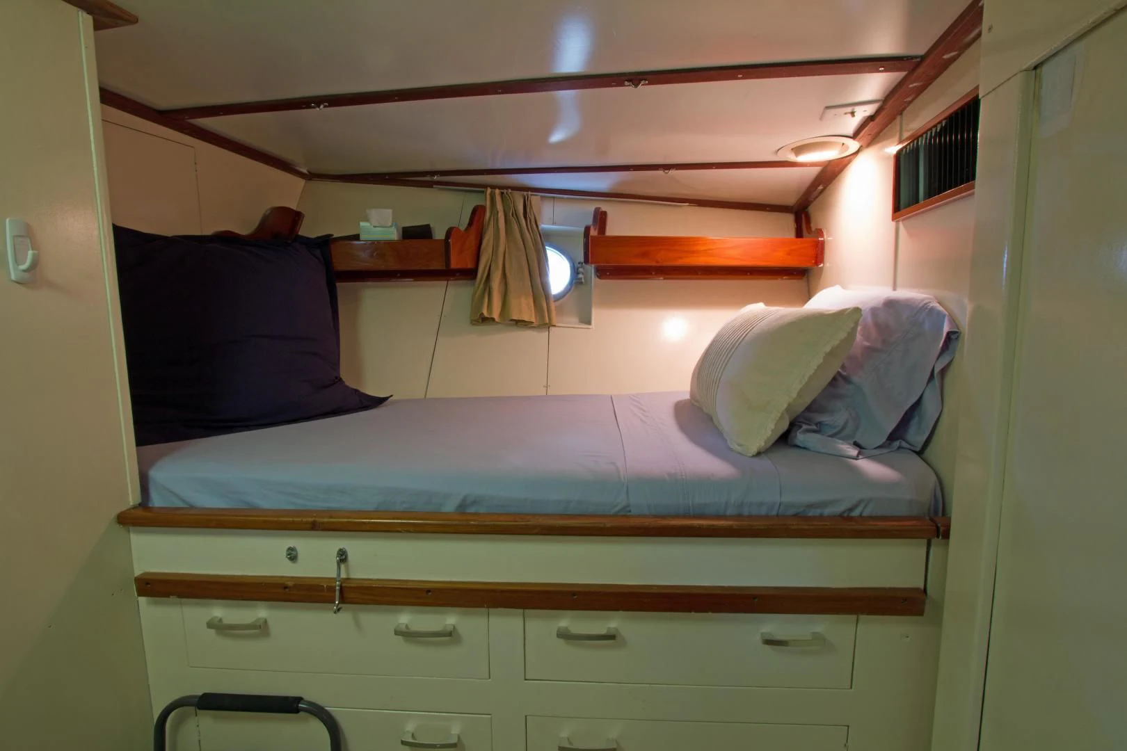 a bed with blue sheets aboard SEA CZAR Yacht for Sale