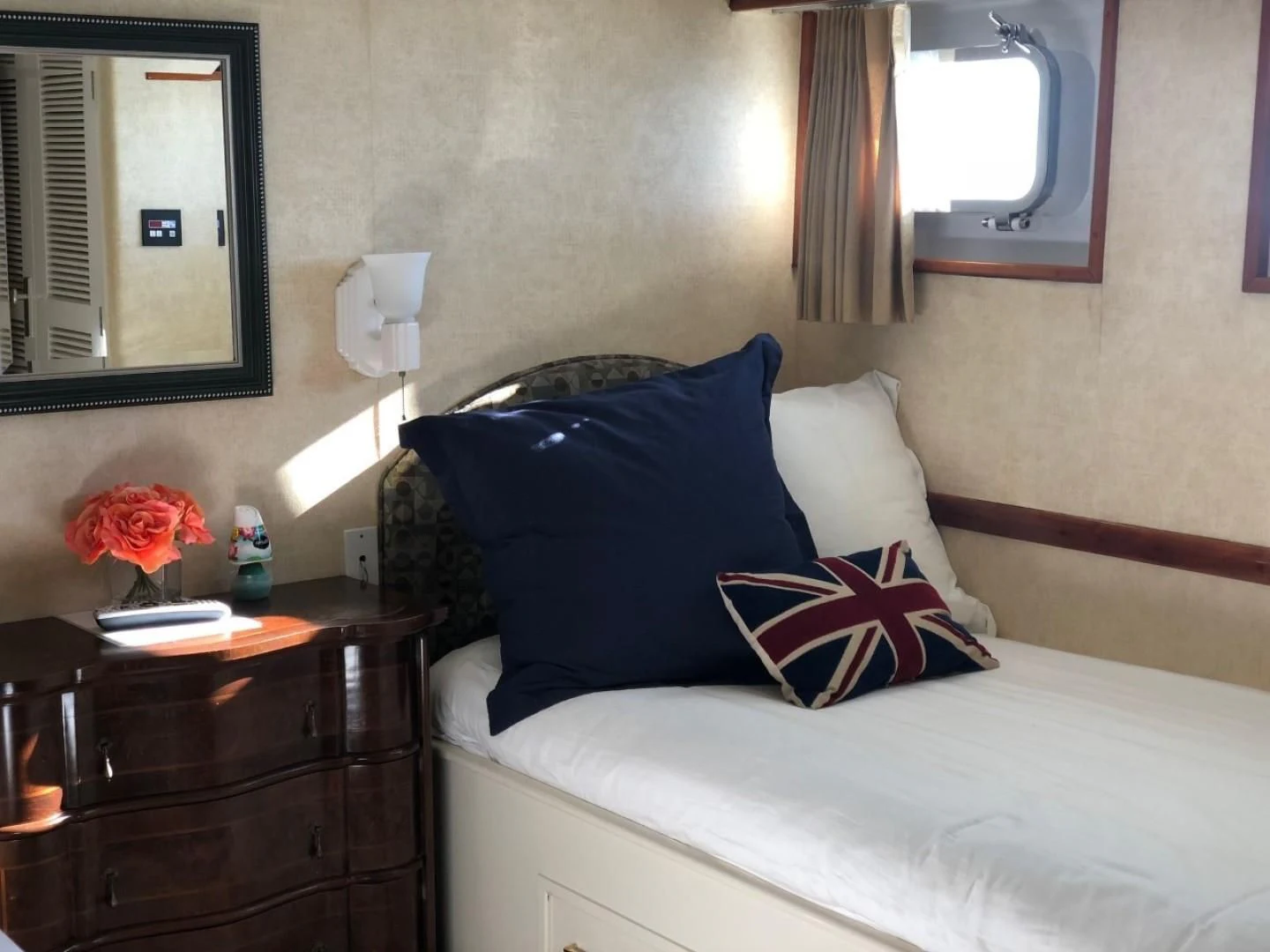 a bed with blue and white pillows aboard SEA CZAR Yacht for Sale