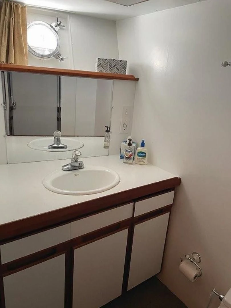 a bathroom with a mirror and a sink aboard SEA CZAR Yacht for Sale