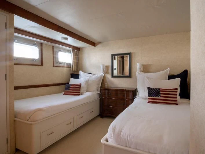 a bedroom with two beds aboard SEA CZAR Yacht for Sale