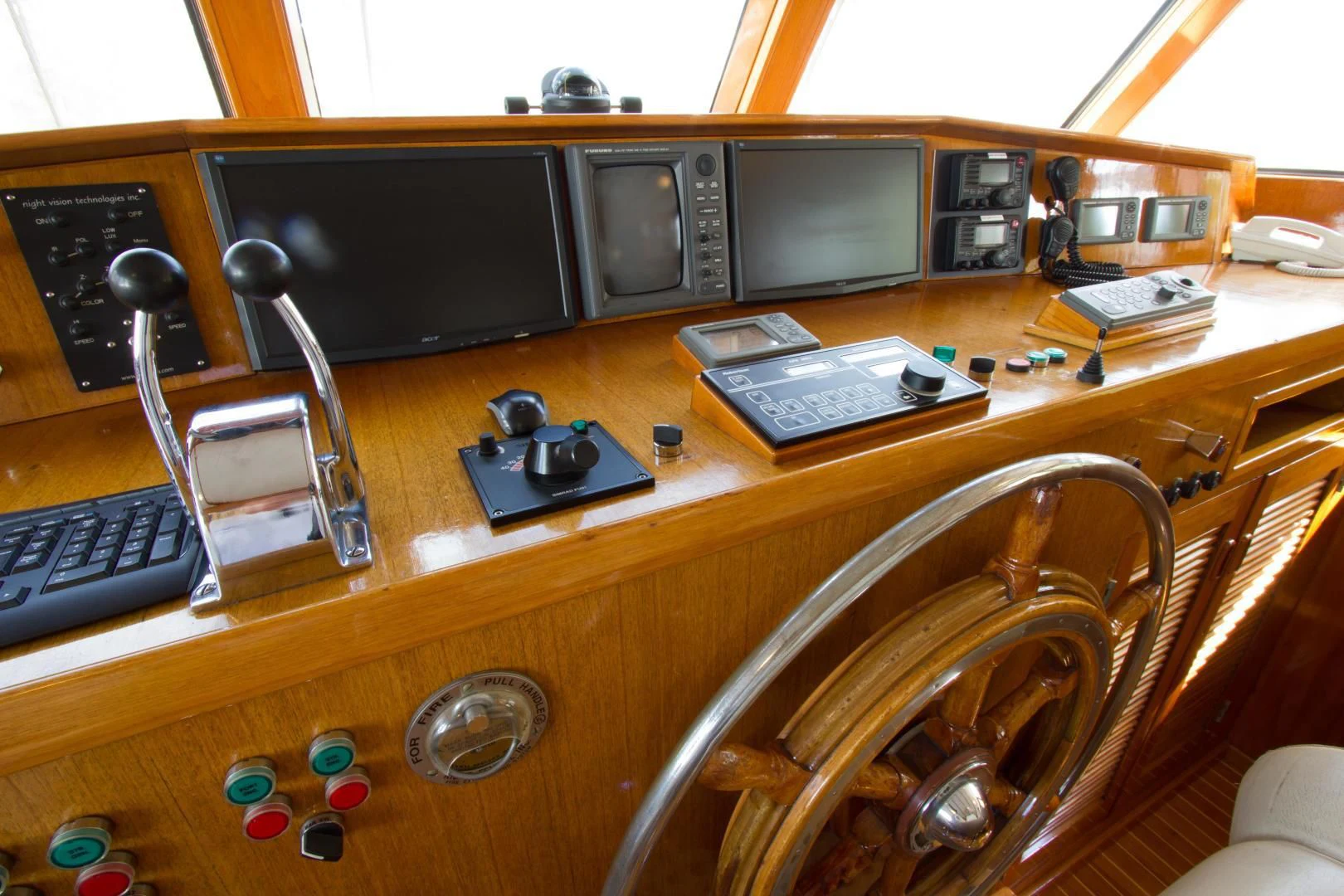 a wooden desk with a computer and other electronics on it aboard SEA CZAR Yacht for Sale