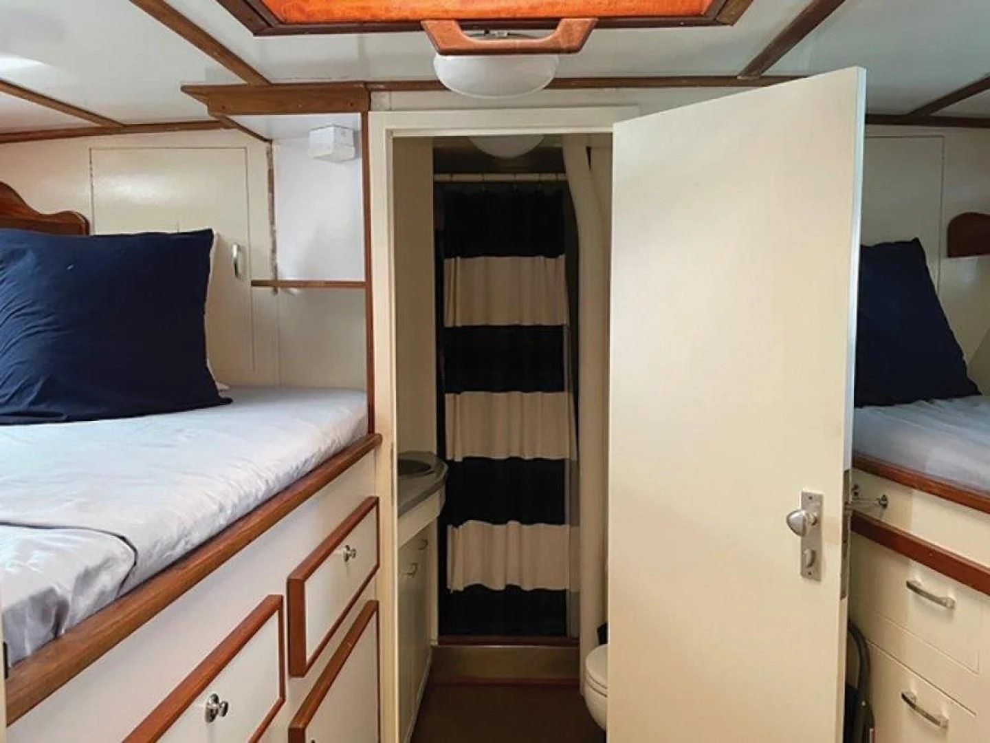 a room with a bed and a closet aboard SEA CZAR Yacht for Sale
