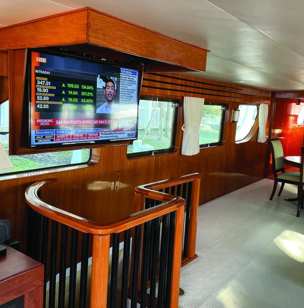 a room with a tv and chairs aboard SEA CZAR Yacht for Sale